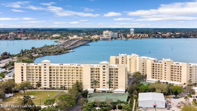birds eye view of property with a water view and a city view