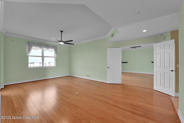 unfurnished room with a ceiling fan, light wood-type flooring, ornamental molding, and baseboards
