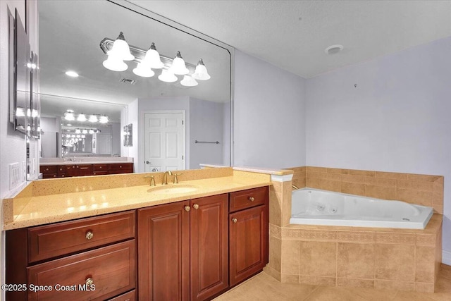 bathroom with visible vents, a jetted tub, tile patterned flooring, and vanity