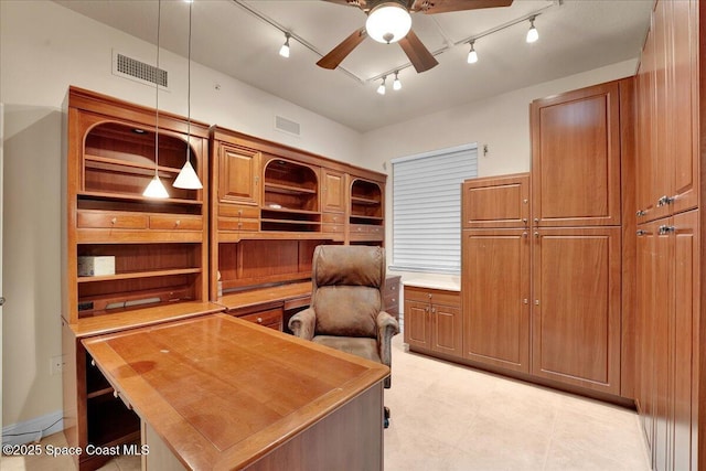 home office with visible vents and ceiling fan