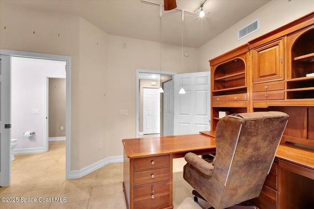office featuring rail lighting, visible vents, baseboards, and light tile patterned floors