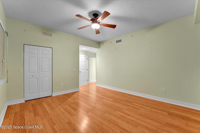 unfurnished bedroom featuring light wood-type flooring, baseboards, and visible vents
