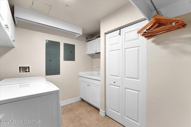 laundry area featuring washing machine and dryer, cabinet space, a sink, and electric panel