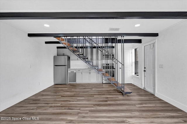 interior space featuring visible vents, dark wood finished floors, beamed ceiling, stairs, and recessed lighting