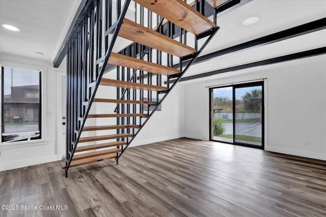 interior space with stairs, recessed lighting, baseboards, and wood finished floors