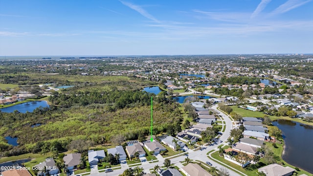 drone / aerial view featuring a water view and a residential view