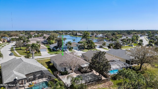 drone / aerial view featuring a residential view and a water view