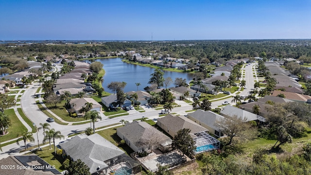 drone / aerial view featuring a water view and a residential view