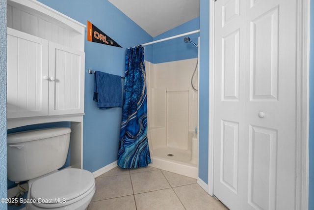 bathroom with toilet, tile patterned flooring, baseboards, and a shower stall