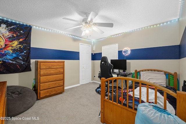 bedroom featuring carpet floors, ceiling fan, and a textured ceiling