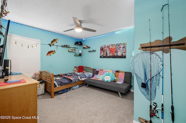 bedroom featuring a textured ceiling, ceiling fan, and light colored carpet