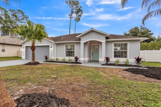 single story home with a front lawn, concrete driveway, and stucco siding