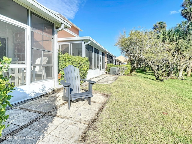 view of yard featuring a patio and a sunroom