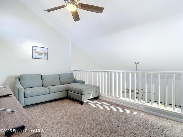 living room featuring lofted ceiling, ceiling fan, a textured ceiling, and carpet flooring