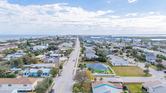 drone / aerial view with a residential view and a water view