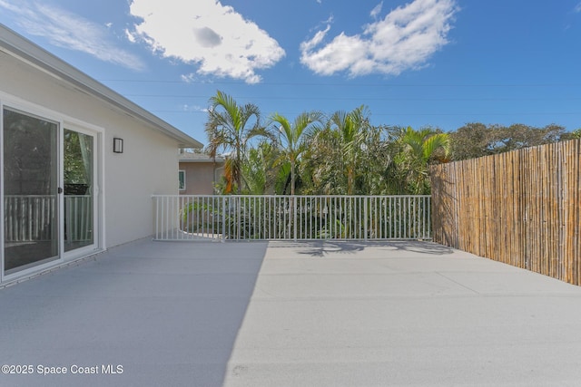 view of patio / terrace featuring fence