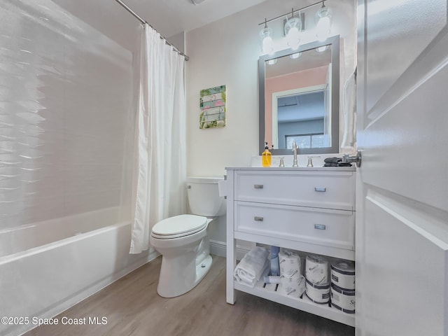 bathroom with shower / bath combination with curtain, vanity, wood finished floors, and toilet