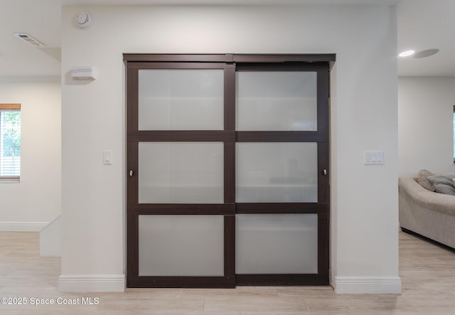 interior details with visible vents, baseboards, and wood finished floors