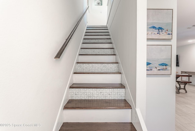 stairway featuring visible vents and wood finished floors