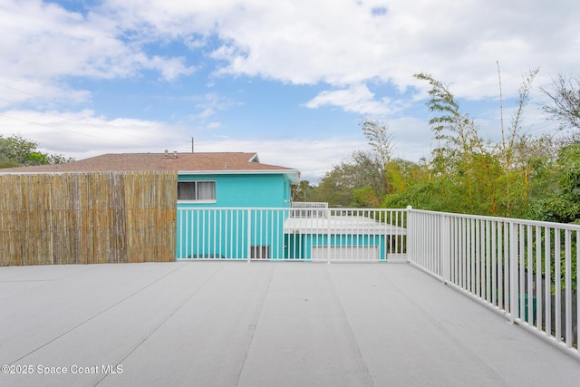 view of patio / terrace featuring fence and a pool