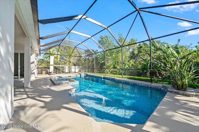 view of swimming pool featuring a pool with connected hot tub, a patio, and a lanai