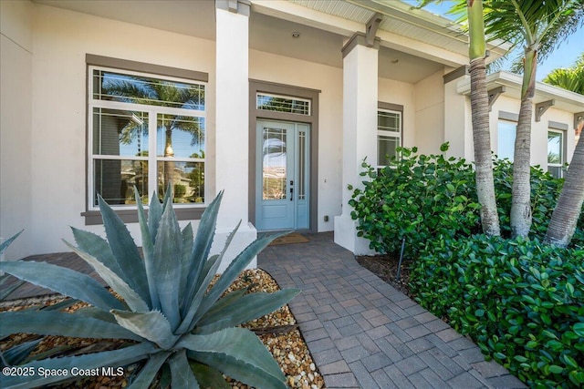 entrance to property featuring stucco siding