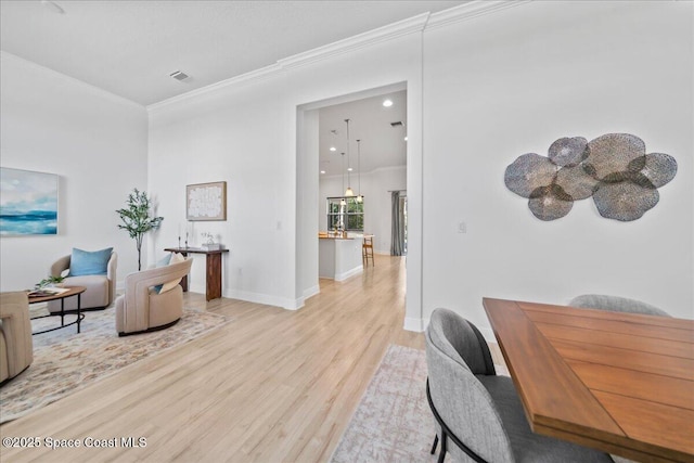 home office with recessed lighting, visible vents, baseboards, light wood-style floors, and ornamental molding