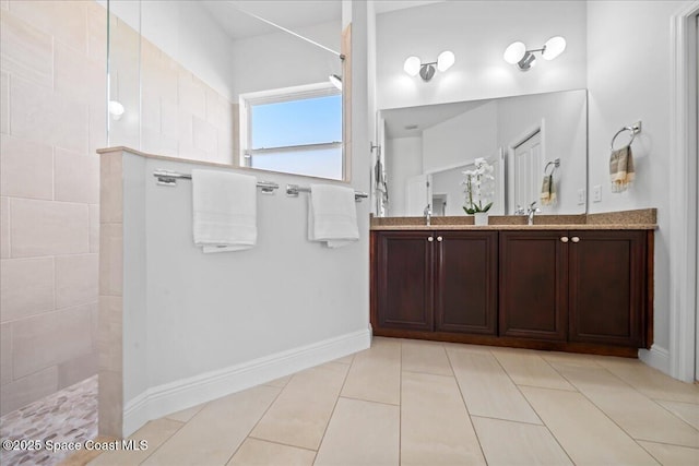 full bathroom featuring a walk in shower, double vanity, tile patterned flooring, and a sink