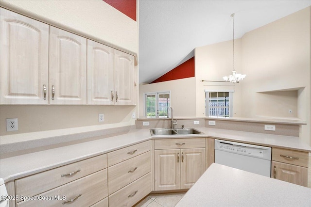 kitchen featuring pendant lighting, light countertops, light brown cabinetry, white dishwasher, and a sink