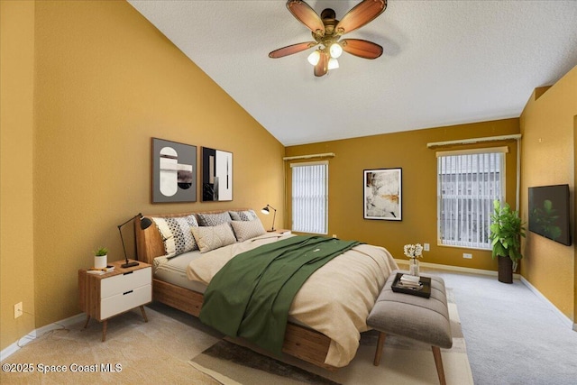 bedroom featuring a ceiling fan, lofted ceiling, light carpet, and baseboards