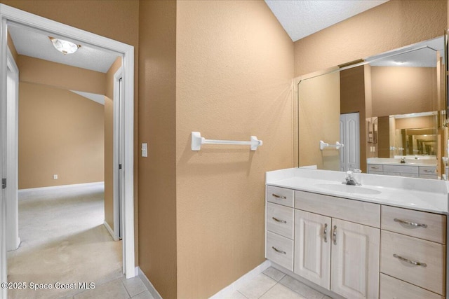 bathroom featuring tile patterned floors, baseboards, and vanity