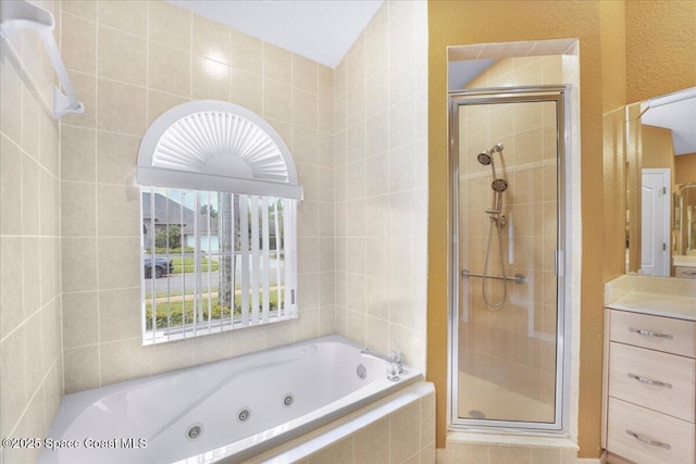 bathroom with a stall shower and a jetted tub