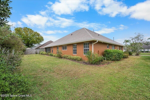 view of side of property with a yard and fence