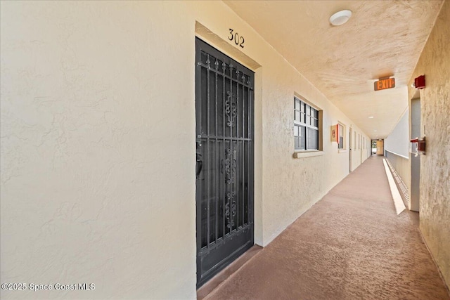 view of exterior entry featuring stucco siding