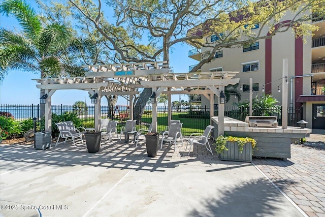 view of property's community featuring a patio area, fence, and a pergola