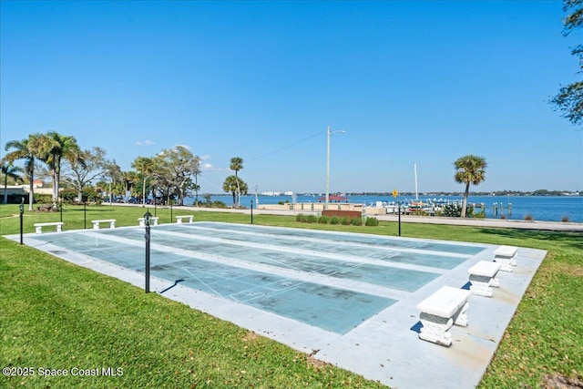 surrounding community featuring shuffleboard and a yard