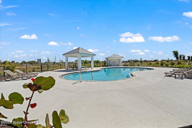 community pool with a gazebo and a patio area