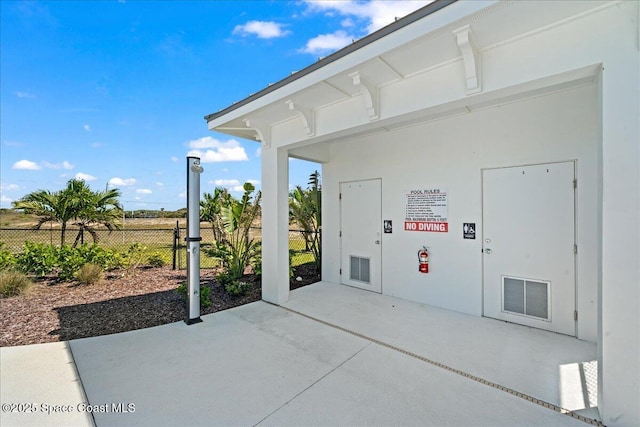 view of patio / terrace with fence and visible vents