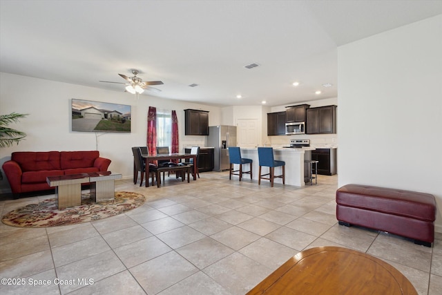 living area with ceiling fan, light tile patterned flooring, visible vents, and recessed lighting