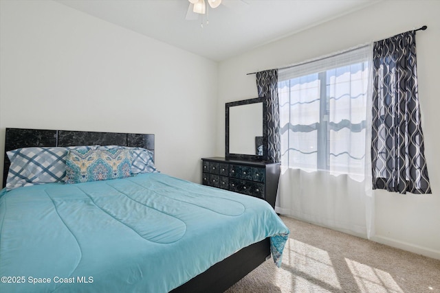 bedroom with light carpet, ceiling fan, and baseboards