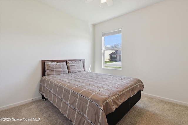 carpeted bedroom featuring a ceiling fan and baseboards