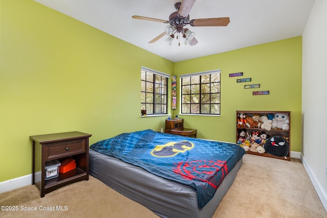 carpeted bedroom featuring baseboards and ceiling fan