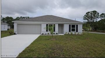 view of front facade with a garage, driveway, and a front lawn