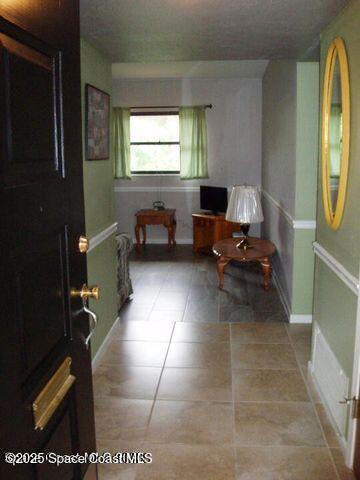 interior space featuring light tile patterned floors and baseboards