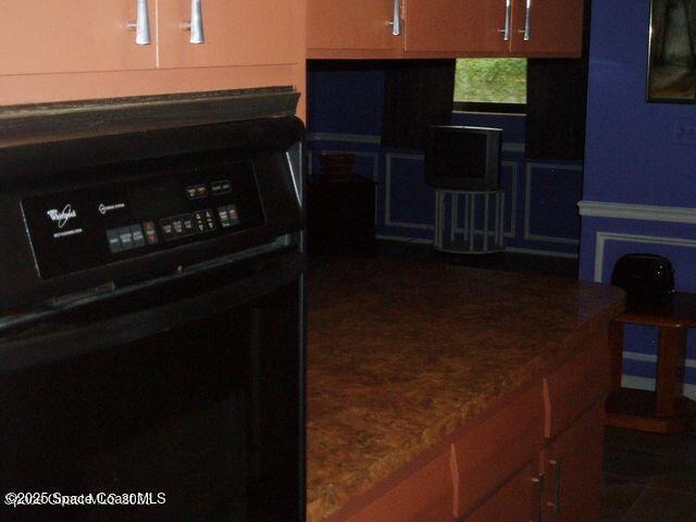 kitchen featuring brown cabinetry and oven