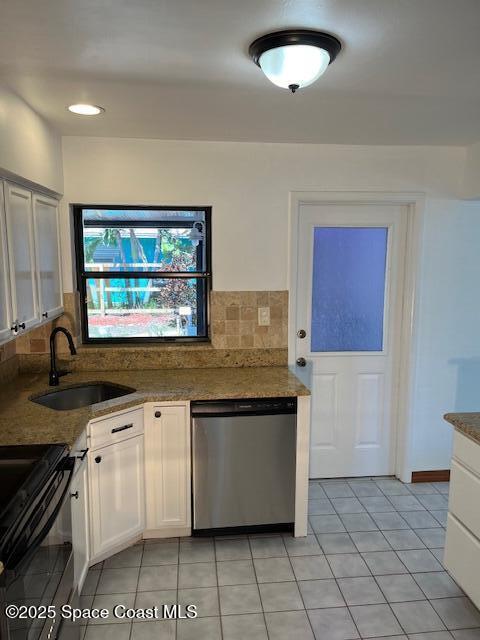 124 E Dover St E, Satellite Beach, FL 32937 - kitchen featuring dishwasher, a sink, range, backsplash, and light tile patterned floors