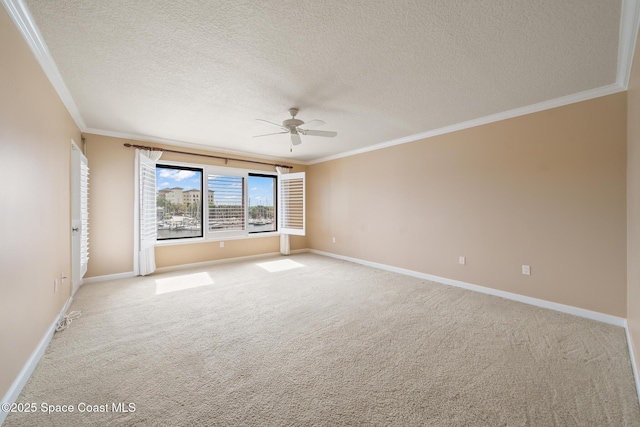 spare room with light carpet, crown molding, baseboards, and ceiling fan