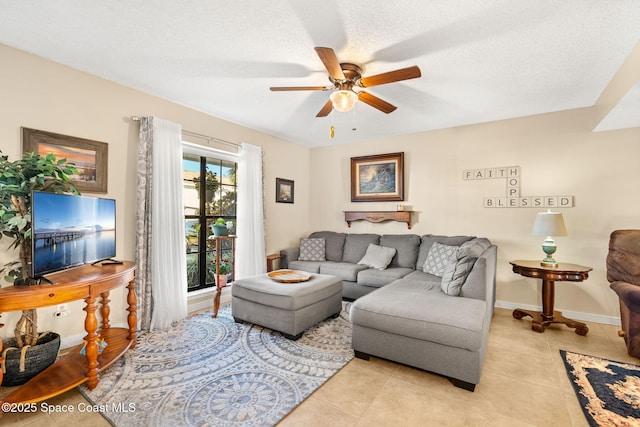 living room with light tile patterned floors, a textured ceiling, baseboards, and a ceiling fan