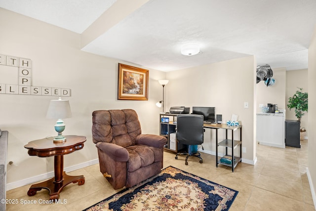 home office featuring baseboards and light tile patterned flooring