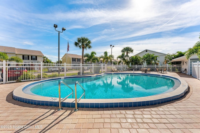 pool featuring a residential view, fence, and a patio